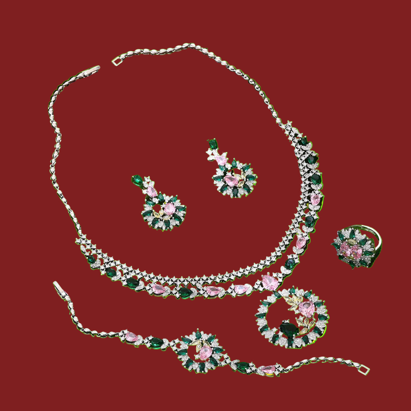 Jewelry set with necklace, earrings, bracelet and ring on a red background