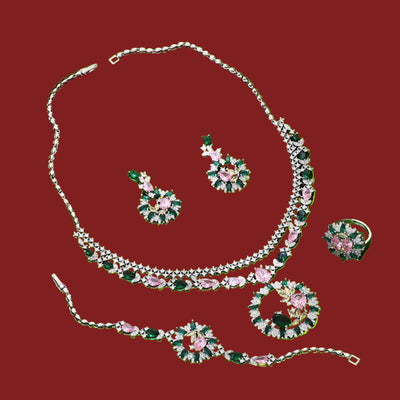 Jewelry set with necklace, earrings, bracelet and ring on a red background