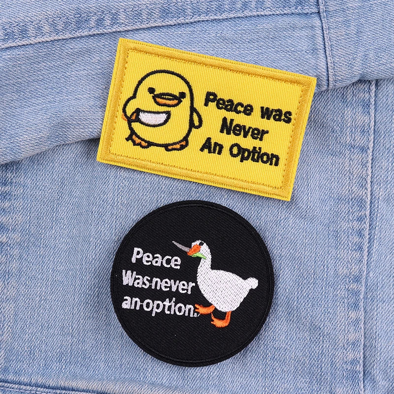 Two patches on a denim jacket: one with a duck and text, the other with a goose and text.