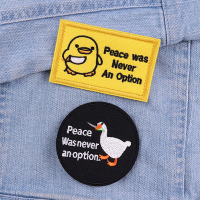 Two patches on a denim jacket: one with a duck and text, the other with a goose and text.