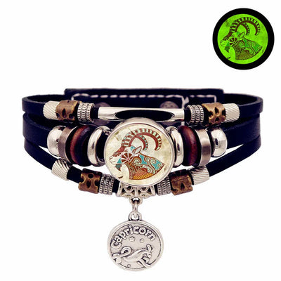 Multistrand leather bracelet with decorative beads and a central pendant on a white background.