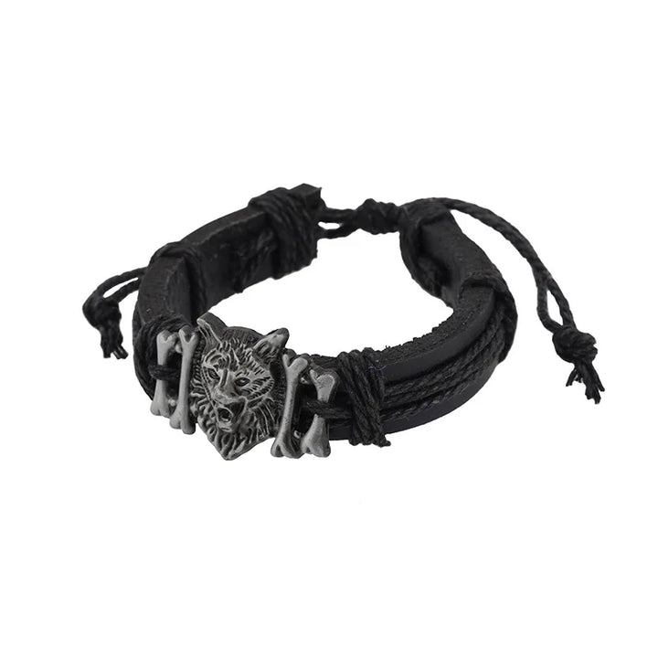 Black woven bracelet with a wolf head charm on a white background