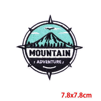 Embroidered patch with mountain design and 'Mountain Adventure' text on a white background