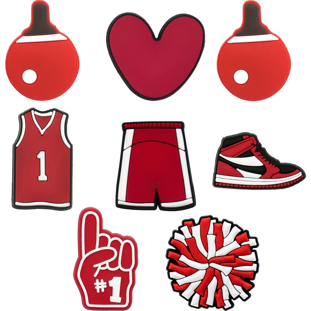 Set of red and white sports-themed shoe charms including a jersey, shorts, shoes, and pom-pom on a white background.