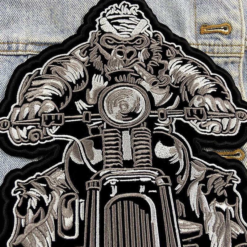 Embroidered patch of a mechanical design on a denim jacket.