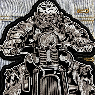 Embroidered patch of a mechanical design on a denim jacket.