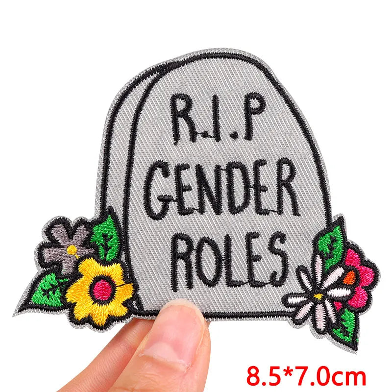 Embroidered patch with 'R.I.P. Gender Roles' text and flowers on a white background