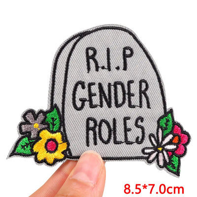 Embroidered patch with 'R.I.P. Gender Roles' text and flowers on a white background