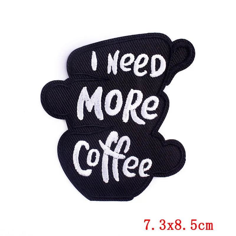Black patch with 'I Need More Coffee' text on a white background