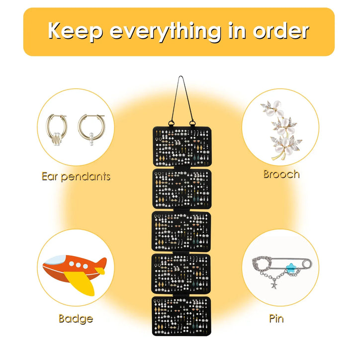 Black hanging organizer with compartments for earrings, brooches, badges, and pins on a yellow background.