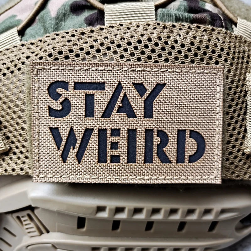 Patch with 'Stay Weird' text on a tactical background