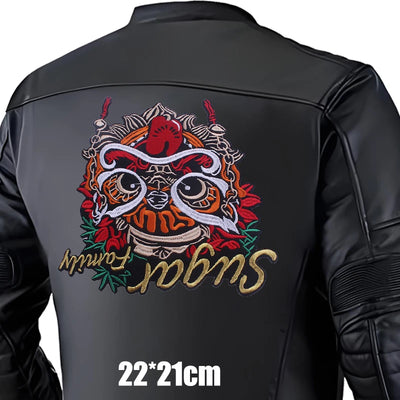 Black leather jacket with colorful embroidered design on the back, featuring text and a logo.