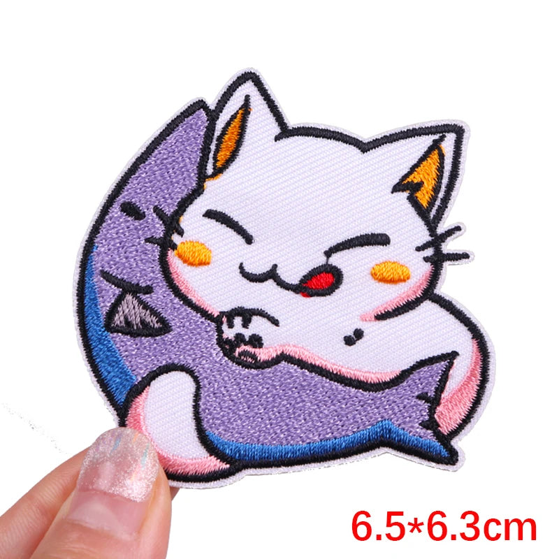 Embroidered patch of a cat-like creature with a fish on a white background
