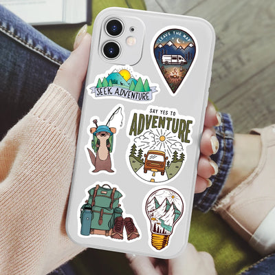 Phone case with adventure-themed stickers held by a person