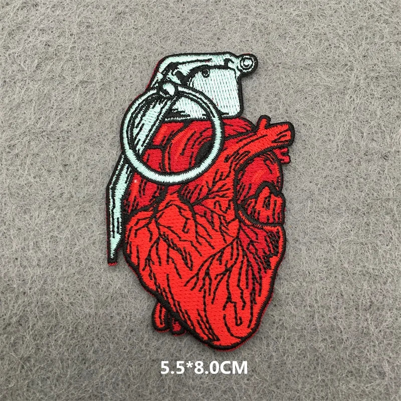 Heart-shaped grenade patch on a gray background