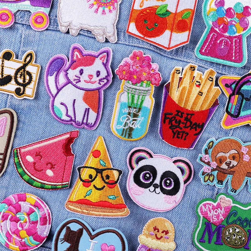 Collection of colorful embroidered patches on a denim fabric background