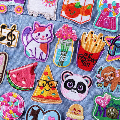Collection of colorful embroidered patches on a denim fabric background