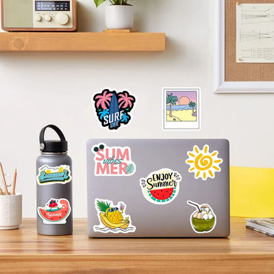 Laptop with summer-themed stickers on a desk, surrounded by a water bottle and decorative items.