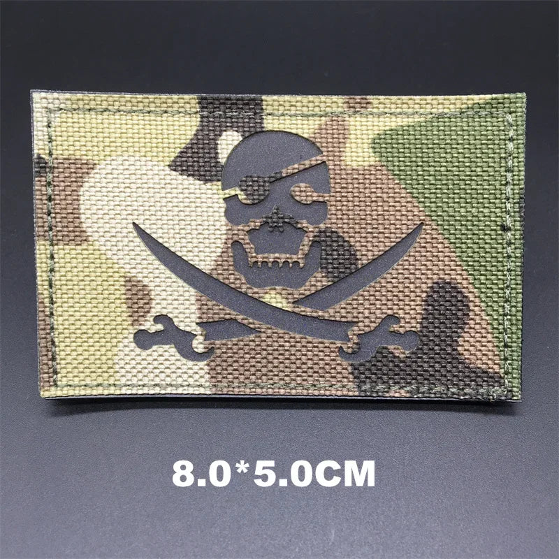 Multicam patch with skull and crossbones design on a dark background