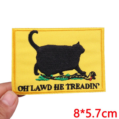 Embroidered patch with a black cat silhouette and text on a yellow background