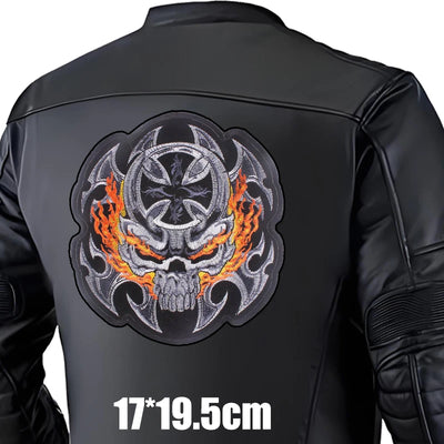 Black leather jacket with a skull and flames design on the back, size indicated.
