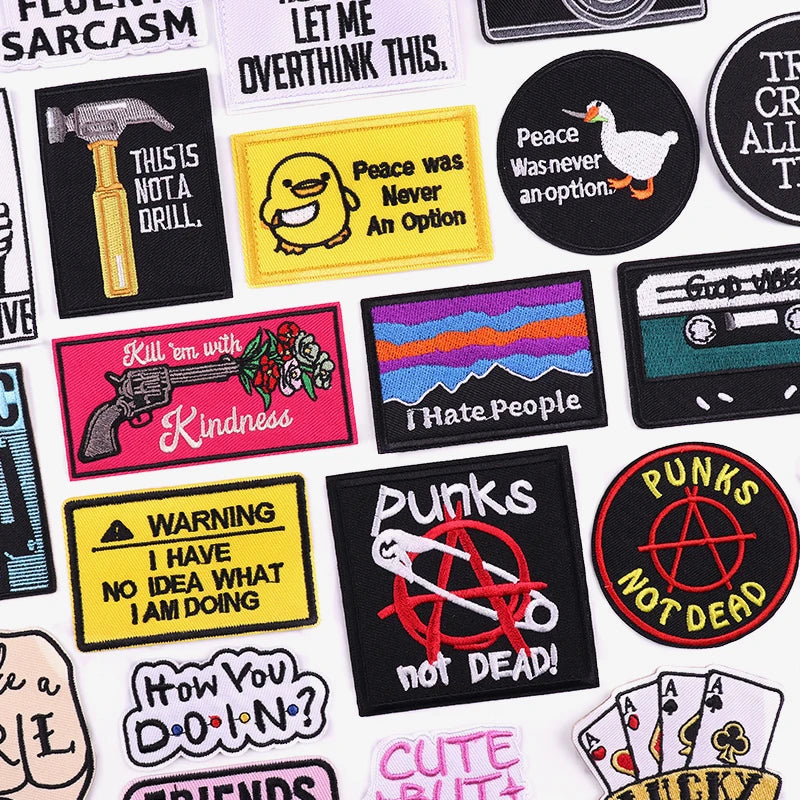 Collection of various patches with different designs and text on a white background