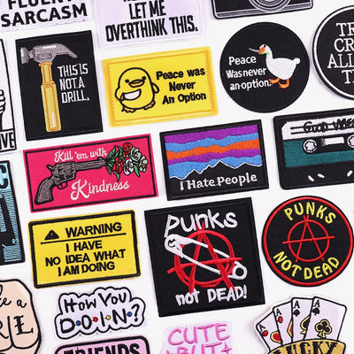 Collection of various patches with different designs and text on a white background