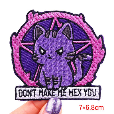 Embroidered patch with a purple cat-like creature and text 'Don't make me hex you' on a white background.
