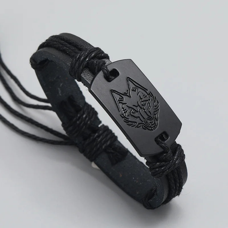 Black leather bracelet with a engraved tag on a light gray background