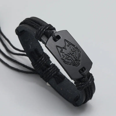 Black leather bracelet with a engraved tag on a light gray background