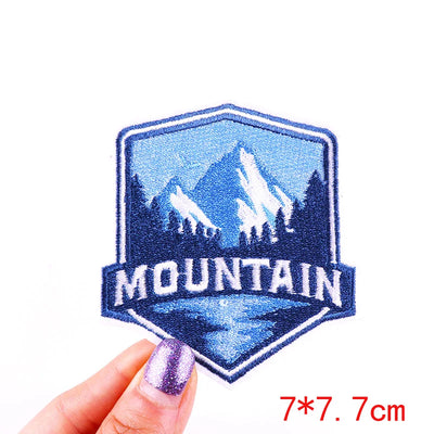 Embroidered patch with mountain design held by a hand, size 7*7.7cm