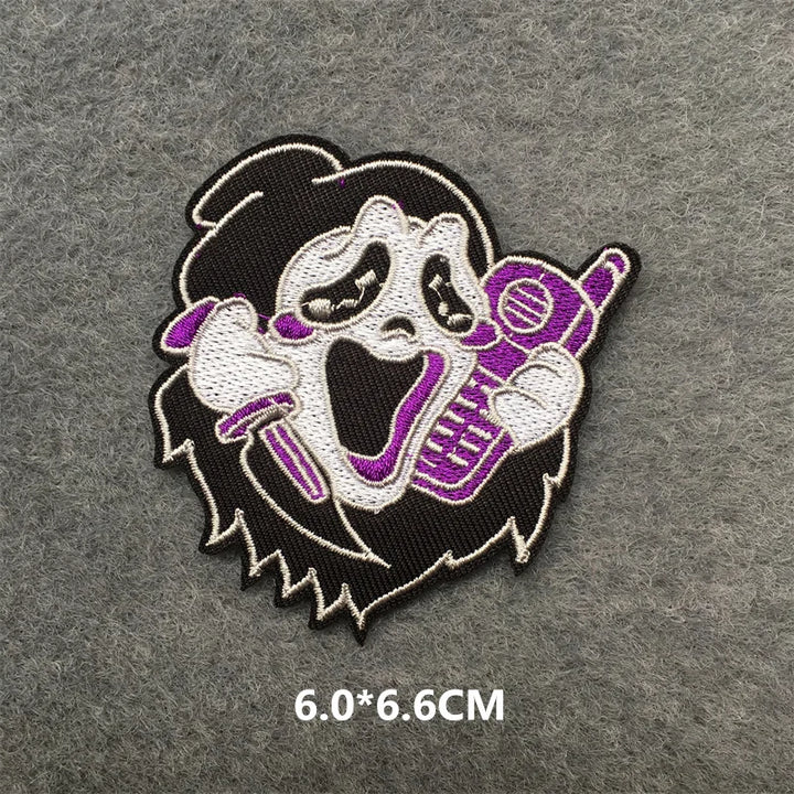 Embroidered patch of a character with a microphone on a gray background