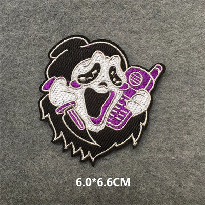 Embroidered patch of a character with a microphone on a gray background