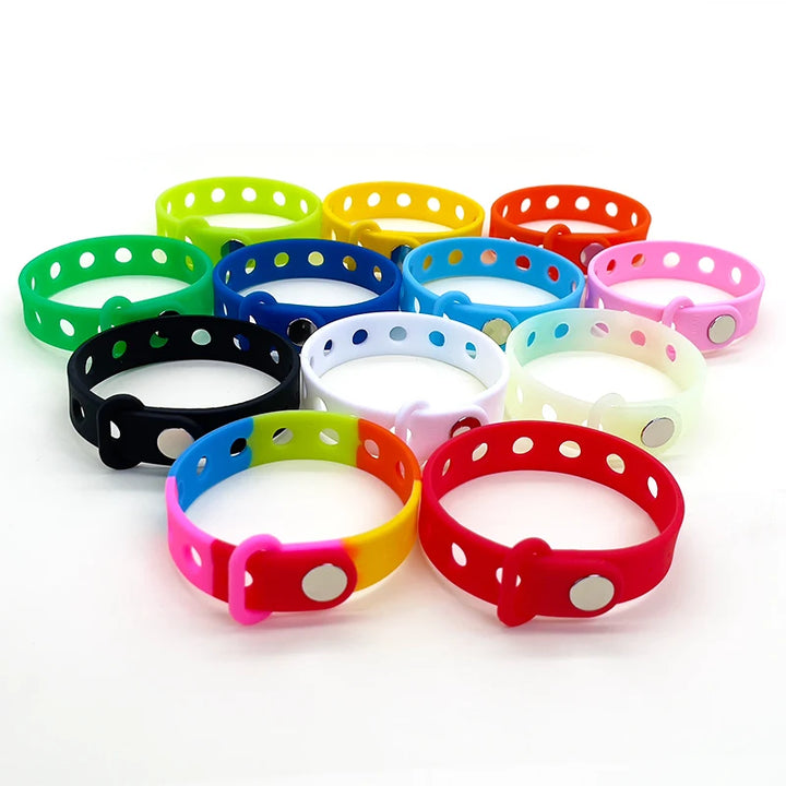 Colorful wrist bands with holes on a white background