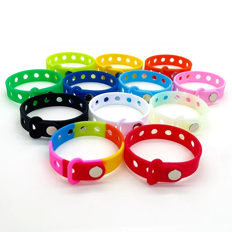 Colorful wrist bands with holes on a white background