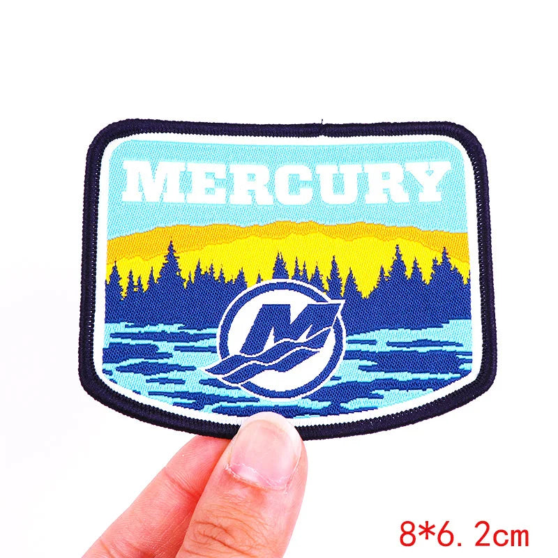 Patch with 'Mercury' branding held by a hand on a white background
