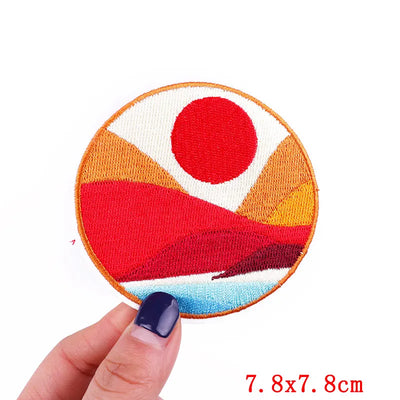 Colorful circular patch held by a hand with a white background