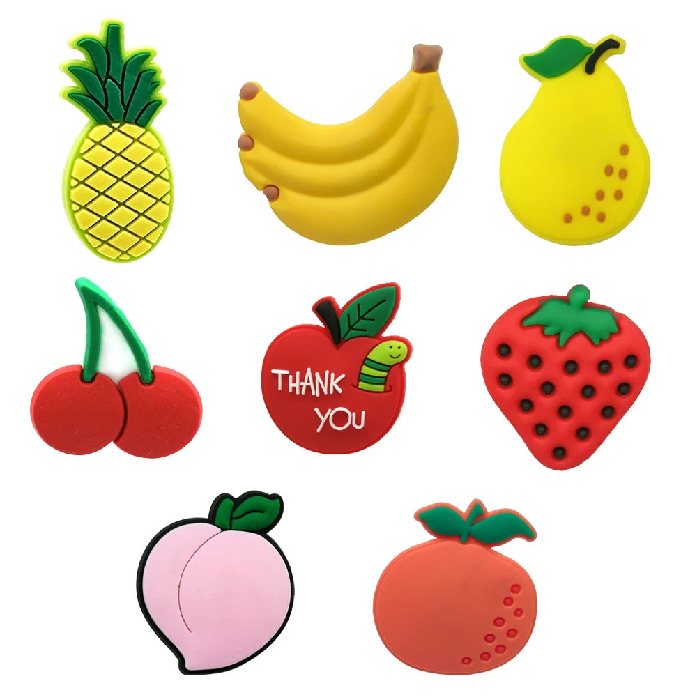 Set of colorful fruit-shaped shoe charms on a white background