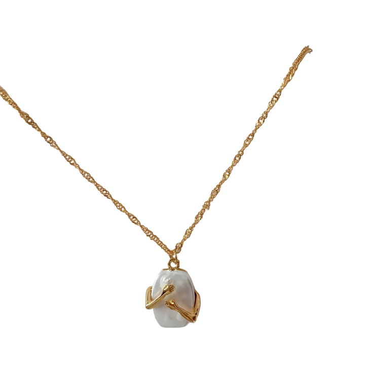 Gold necklace with a pearl pendant on a white background