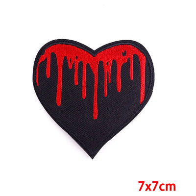 Heart-shaped patch with red dripping design on a black background, size 7x7cm.