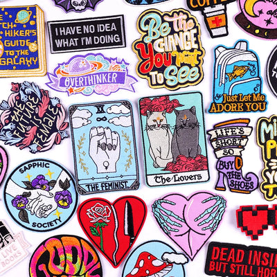 Collection of colorful stickers with various designs and text on a white background