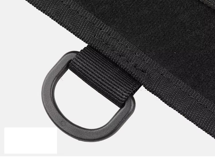 Close-up of black patch display boards showing edges and the plastic hook attached on a white background