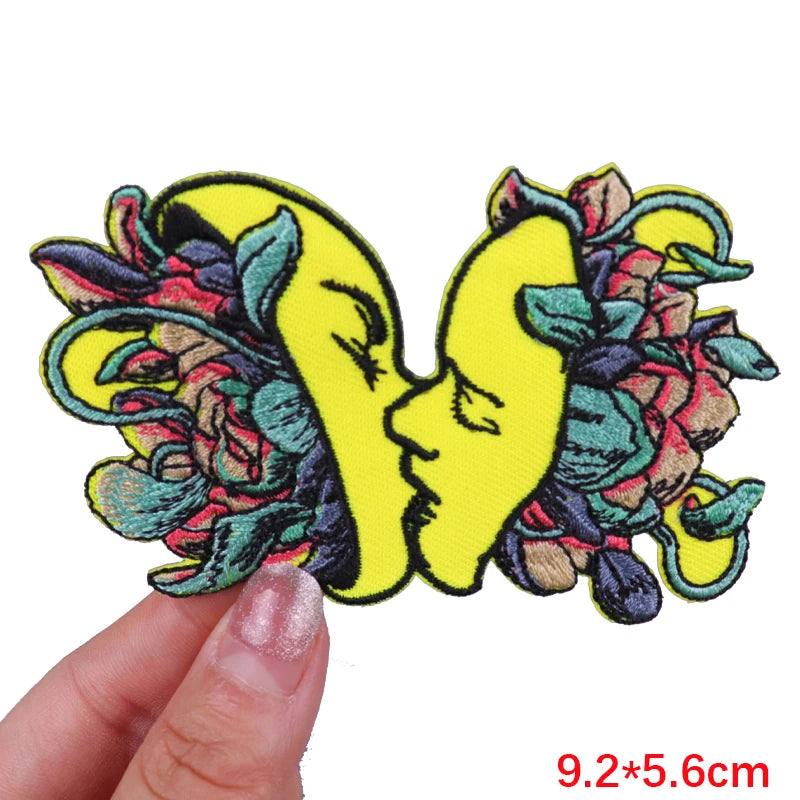 Colorful butterfly patch held by a hand with dimensions displayed
