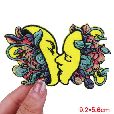 Colorful butterfly patch held by a hand with dimensions displayed