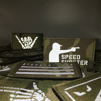 Collection of tactical patches with various designs on a dark background