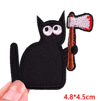 Black cat patch holding an axe with a white background