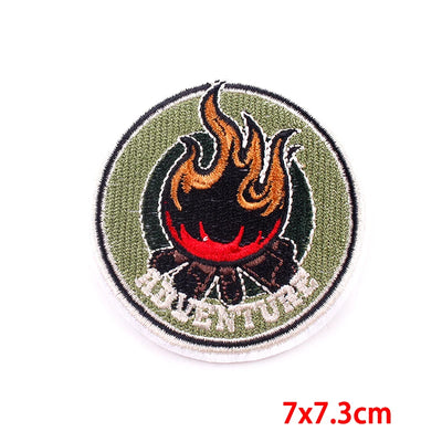 Round embroidered patch with flames and 'ADVENTURE' text on a white background