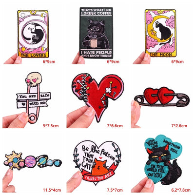 Collection of various stickers with different designs and text, held by hands against a white background.