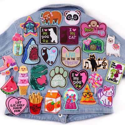 Denim jacket with various colorful patches on a white background