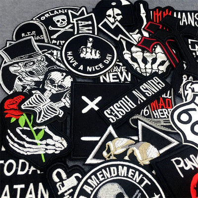 Collection of various patches with different designs and text on a gray background